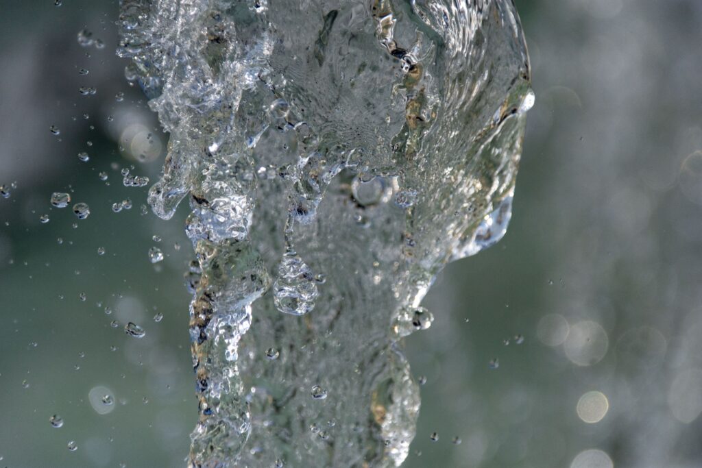 Dynamic capture of water droplets mid-air, highlighting texture and flow.